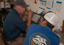 photo of sckn talking with another person at desk area