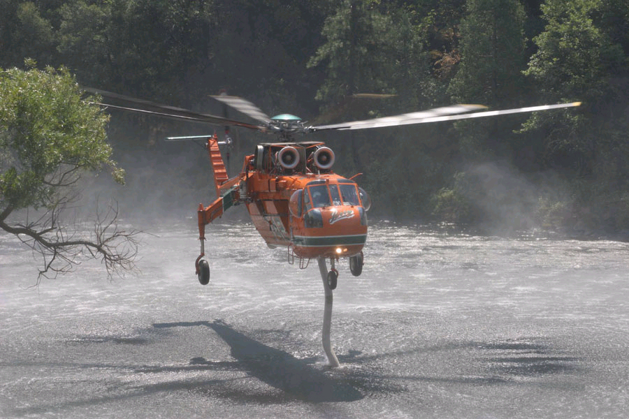 helicopter drawing water from a river