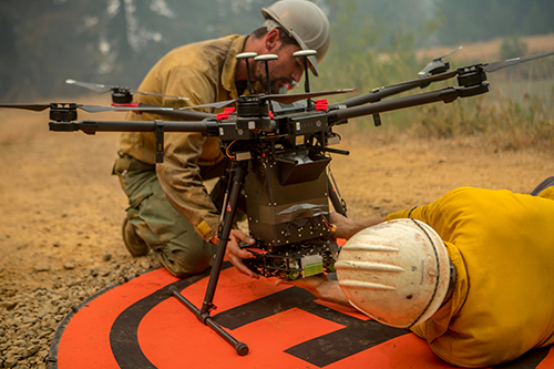 Photo of firefighter and drone.  Decorative.