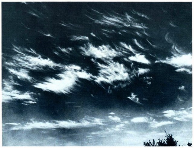 Cirrus clouds against a dark sky.