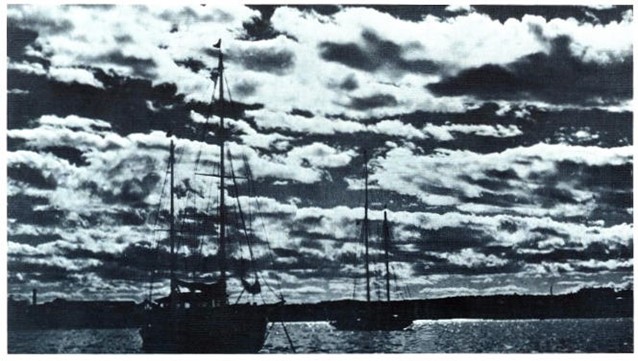 Stratocumulus clouds with some anchored sailboats in the middle ground.