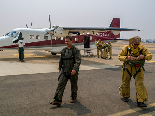 Photo of smokejumpers and plane.  Decorative.