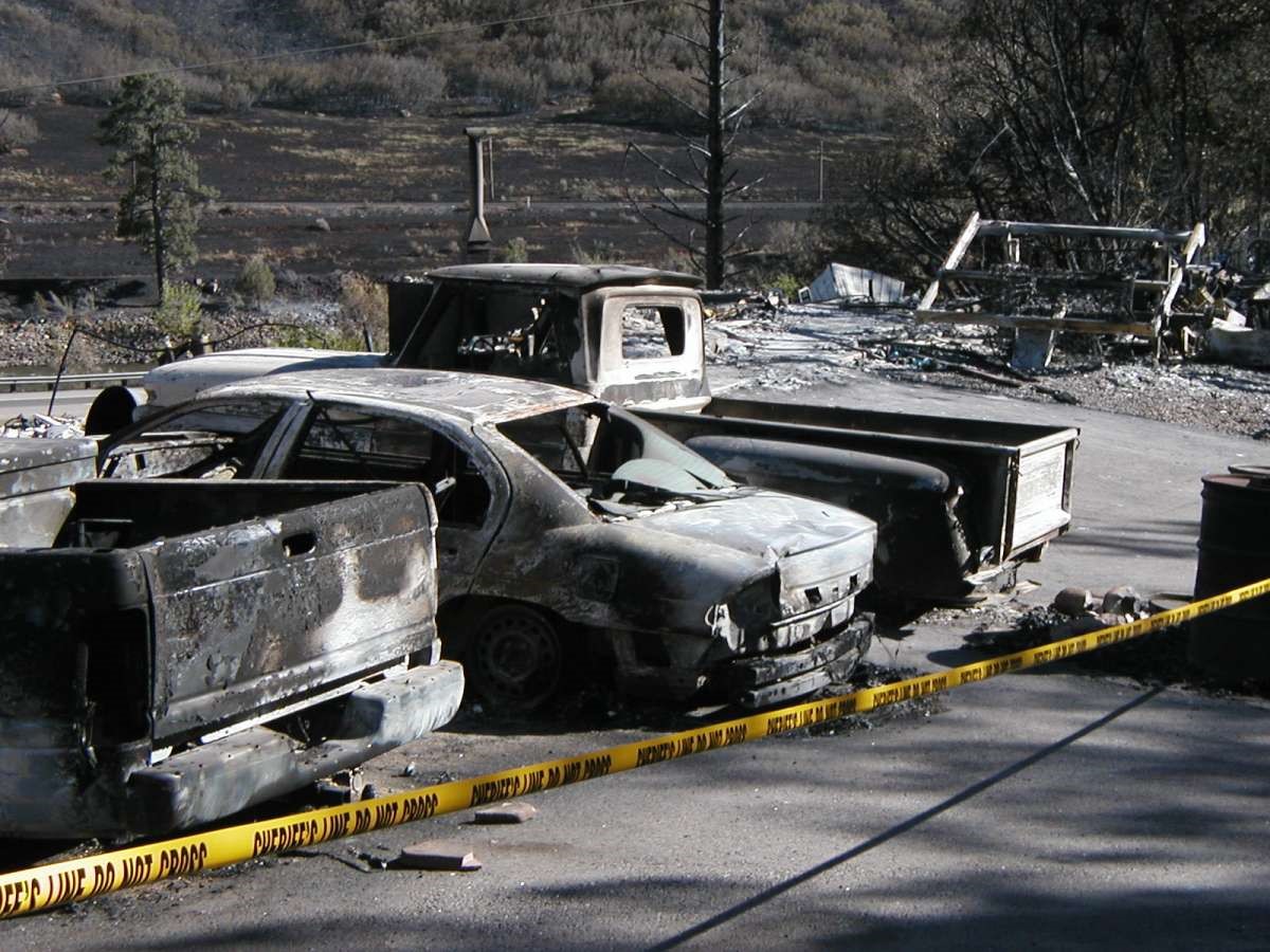 Burned cars on a road.
