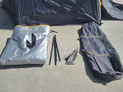 2-person tent bag and parts displayed on ground.