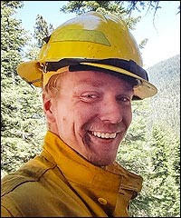 Wildland firefighter smiles at camera.