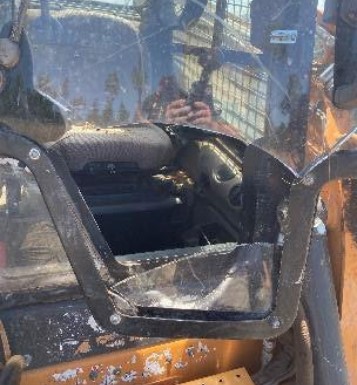 The skid steer glass was smashed by the tree.