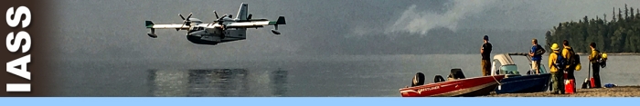 IASS decorative banner. A water Scooper lands on lake with people on shore watching.