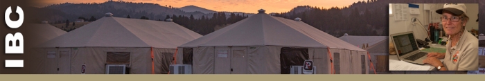 IBC header image of camp tents and a woman smiling, sitting at computer.