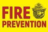 Fire prevention in red letters on bright yellow background with Smokey Bear