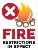 Fire restrictions in effect with illustration of a campfire and red prohibited X