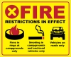 Bright yellow background with red border; "Fire restrictions in effect"; campfire ring icon with "fires in rings at designated campgrounds only" text; smoking icon with "Smoking in campgrounds and enclosed vehicles only" text;  vehicle icon with "vehicles on roads only" text.