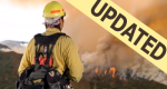 Image of a firefighter as a lookout up on a ridge overseeing the fire across the valley updated.