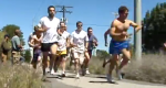 Photo of a group of people running down a path.