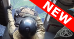 Smokerjumper sitting at opening, getting ready to jump from plane.