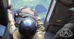 Smokerjumper sitting at opening, getting ready to jump from plane.