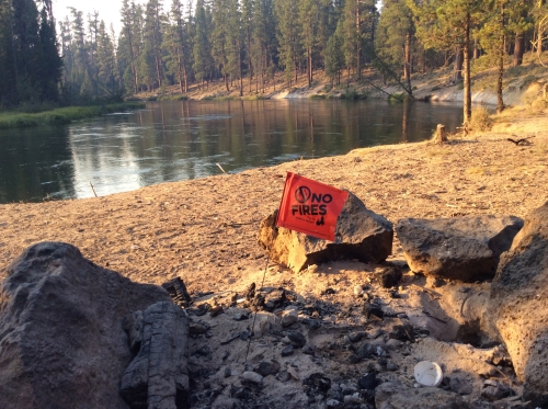 Flag in campfire rock ring